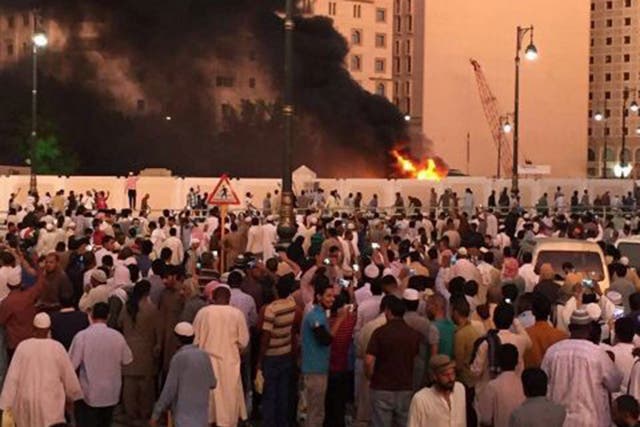 Muslim worshippers gather after a suicide bomber detonated a device near the Prophet's Mosque in Medina