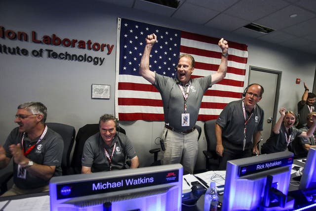 Scientists celebrate in Mission Control at NASA's Jet Propulsion Laboratory as the solar-powered Juno spacecraft goes into orbit around Jupiter