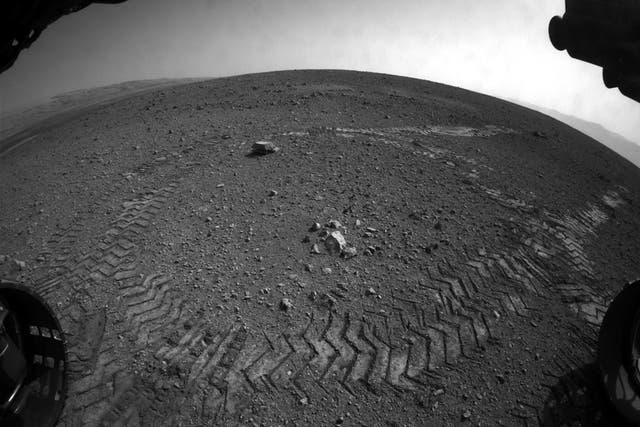 Tracks left by NASA's Curiosity rover as it completed its first test drive on Mars in August 2012