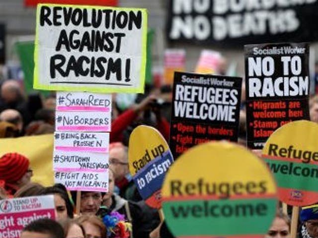 Campaigners from Stand Up to Racism protest through Trafalgar Square in London