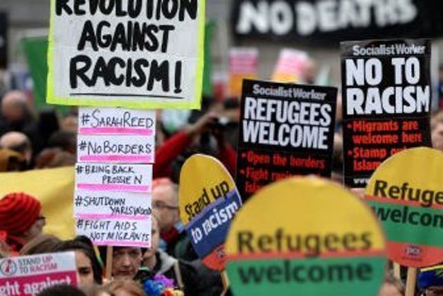 Campaigners from Stand Up to Racism protest through Trafalgar Square in London