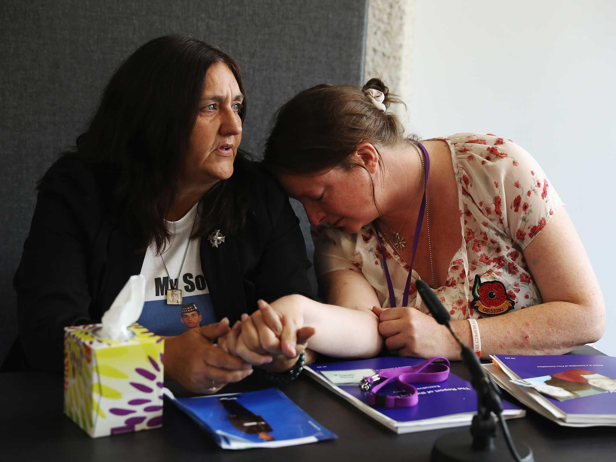 Rose Gentle (left), the mother of 19-year-old Gordon Gentle, comforts Sarah O'Connor