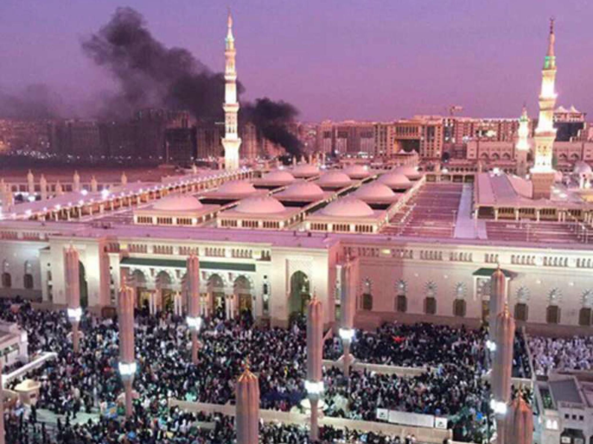 Prophet Mohammed Mosque with smoke rising in the background in the holy city of Medina, in Saudi Arabia