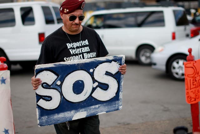 U.S. Army veteran Hector Barajas protests the deportation of military personnel at the Tijuana border <em>Sandy Huffaker/Getty</em>