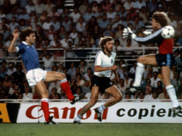 Germany keeper Toni Schumacher charges toward France's Patrick Battiston during the 1982 World Cup semi-final (Getty)