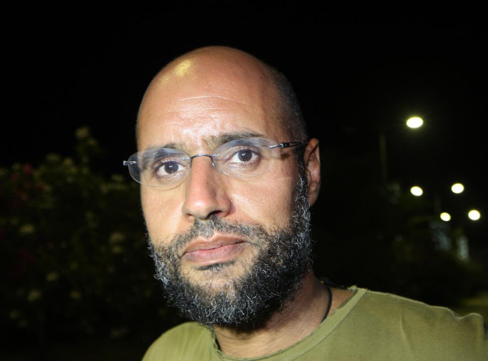 Saif al-Islam Gaddafi outside his father's residential complex in Tripoli in 2011