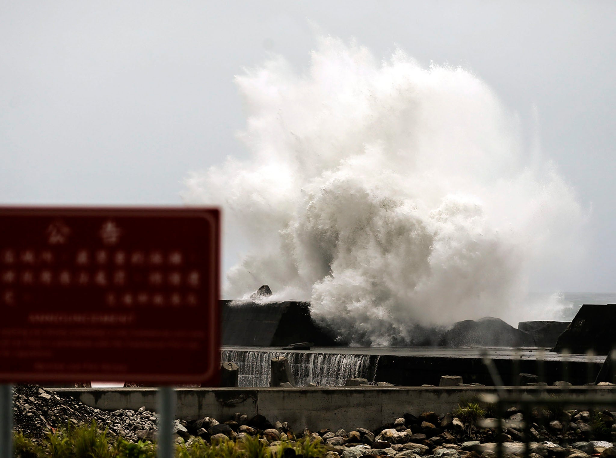 A wave collides with the Taiwanese coastline as typhoon Nepartak moves towards the island