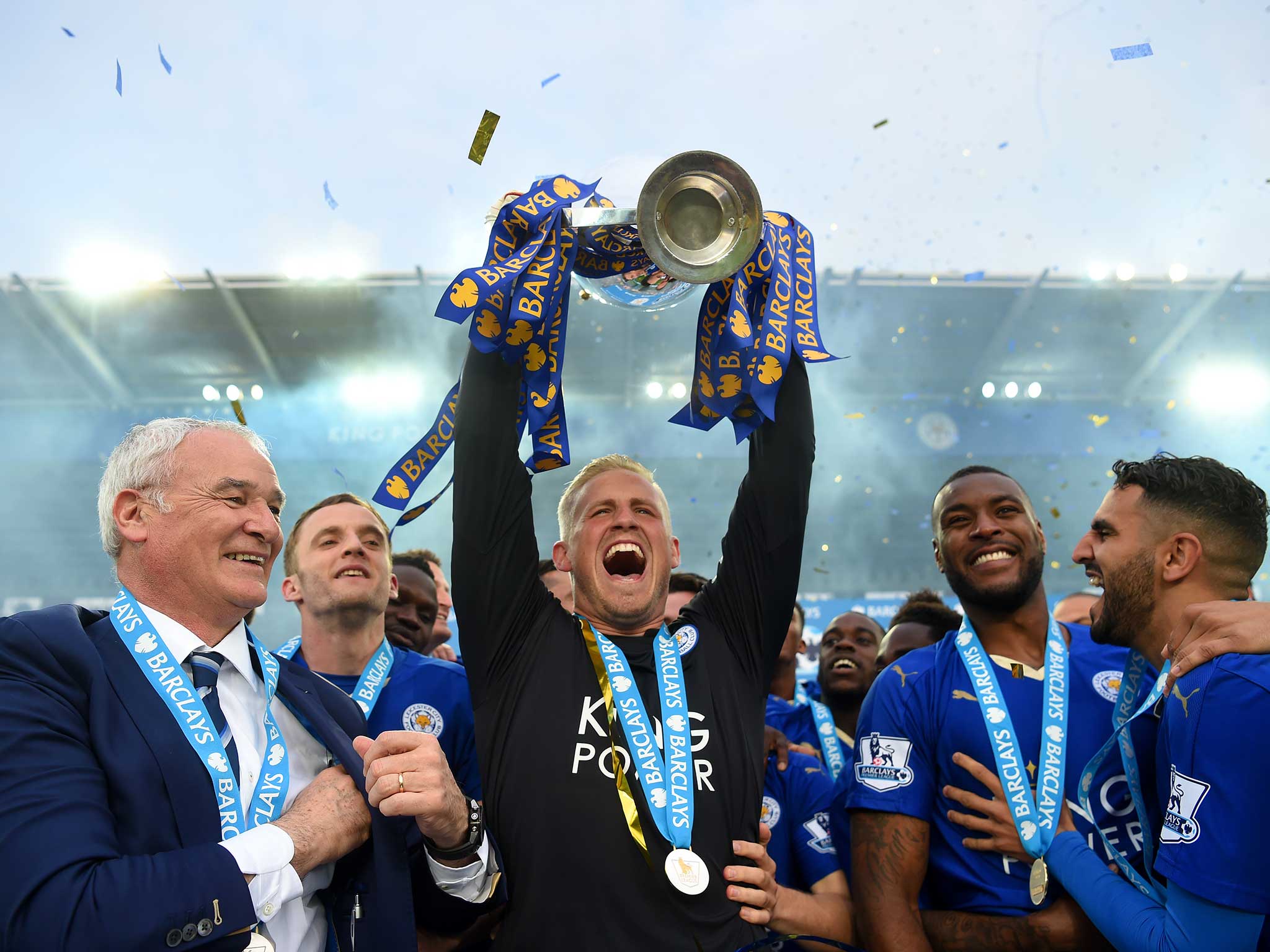 Kasper Schmeichel holds the Premier League trophy aloft as Leicester City are crowned champions
