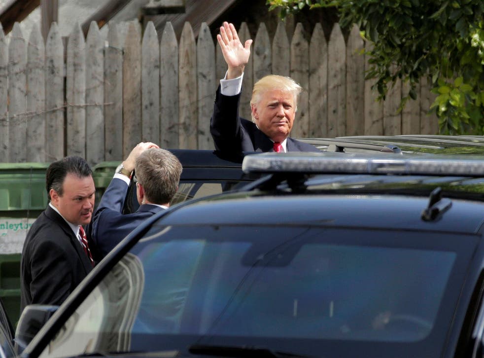 Donald Trump waves as he leaves a meeting with House Republicans at the Capitol Club in Washington DC