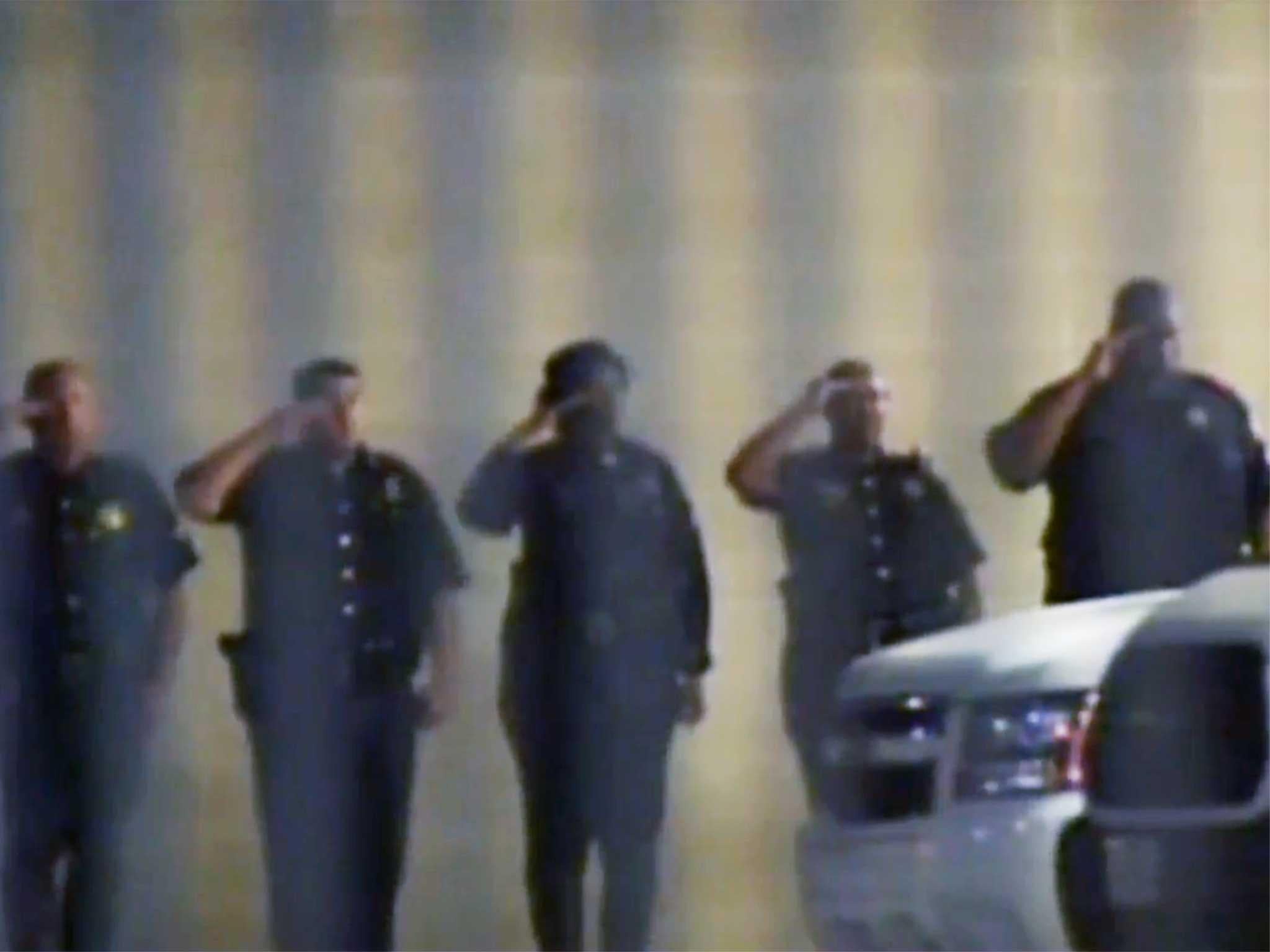 Dallas police line up outside hospital as their colleagues undergo emergency treatment