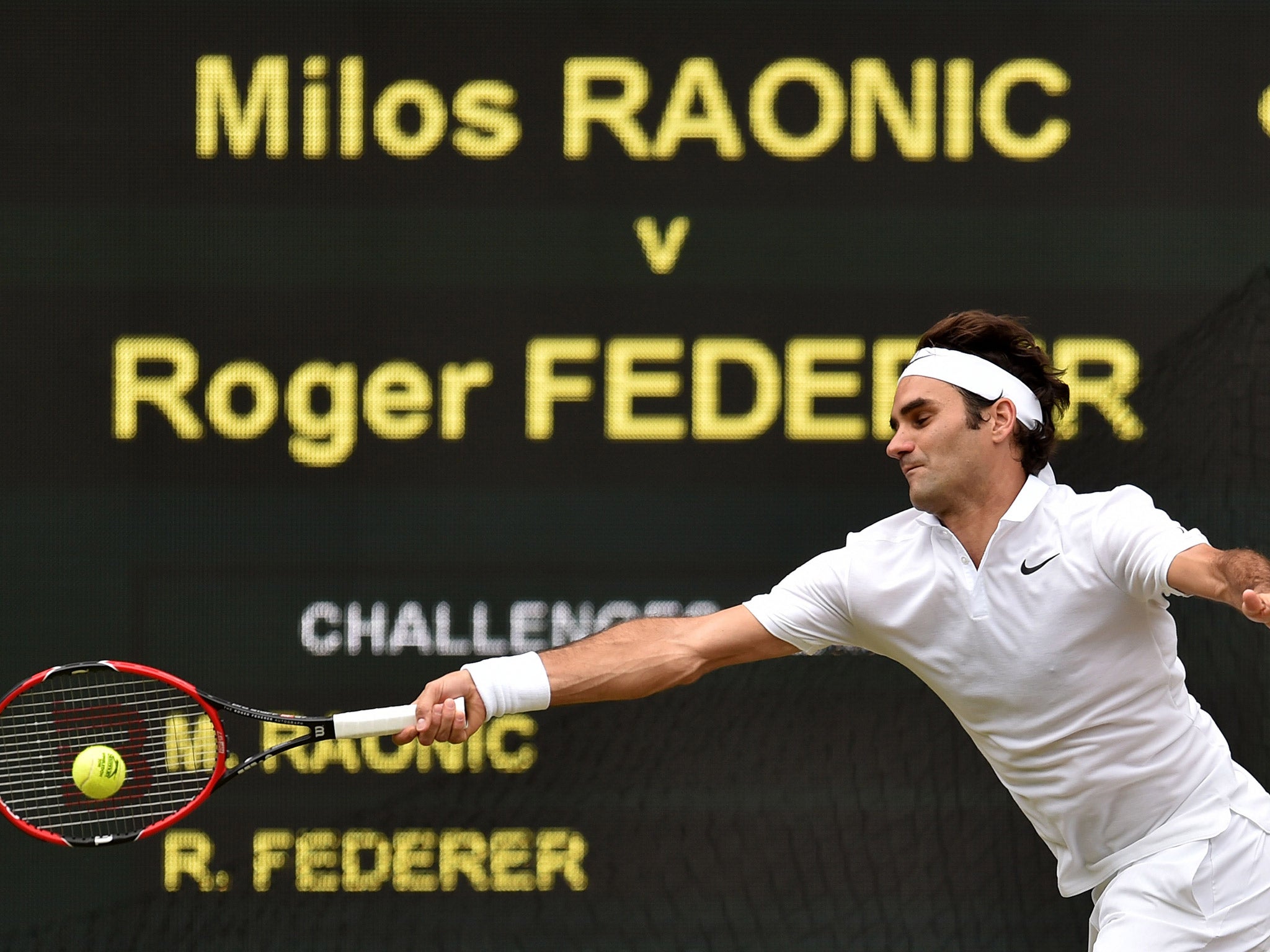 Roger Federer returns during his Wimbledon semi-final with Milos Raonic