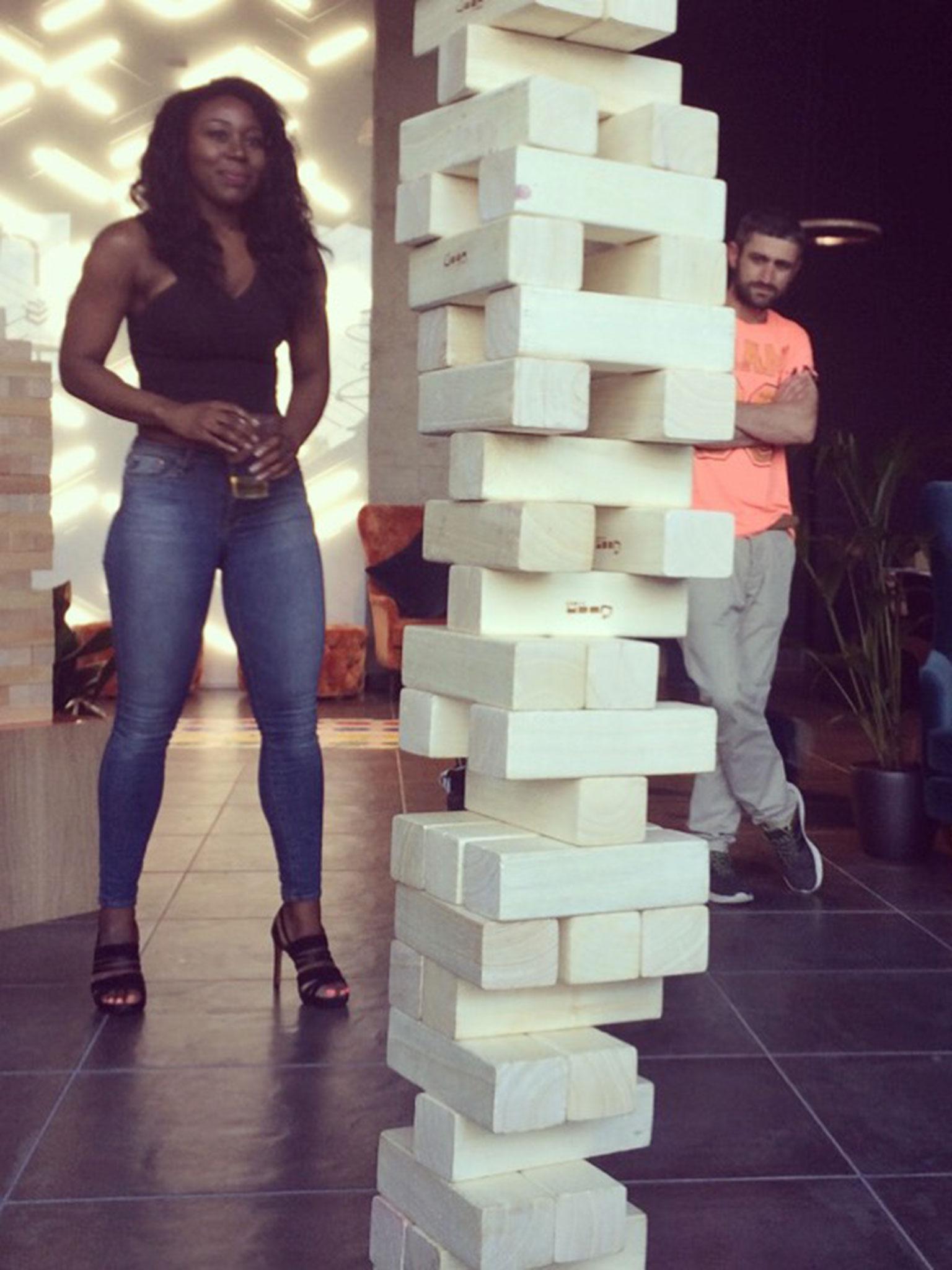 Tracy Eden plays giant jenga with friends at The Collective.