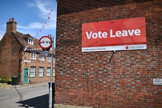 A 'Vote Leave' sign is seen on the side of a building in Charing on June 16, 2016 urging people to vote for Brexit