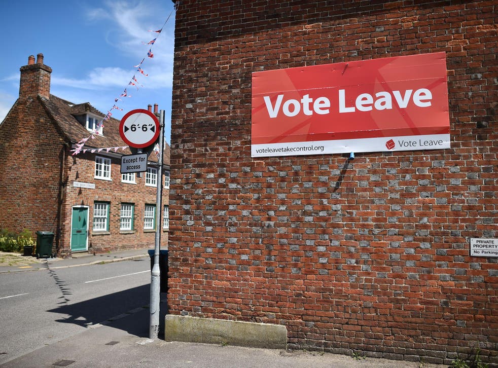 A 'Vote Leave' sign is seen on the side of a building in Charing on June 16, 2016 urging people to vote for Brexit
