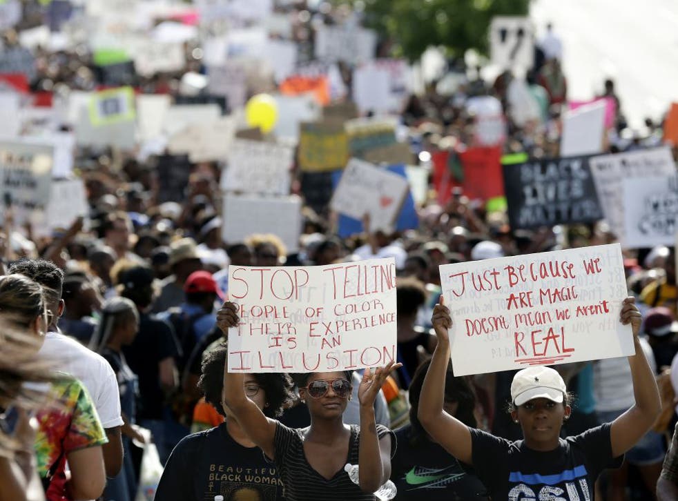 Demonstrators march through downtown Atlanta to protest the shootings of two black men by police officers