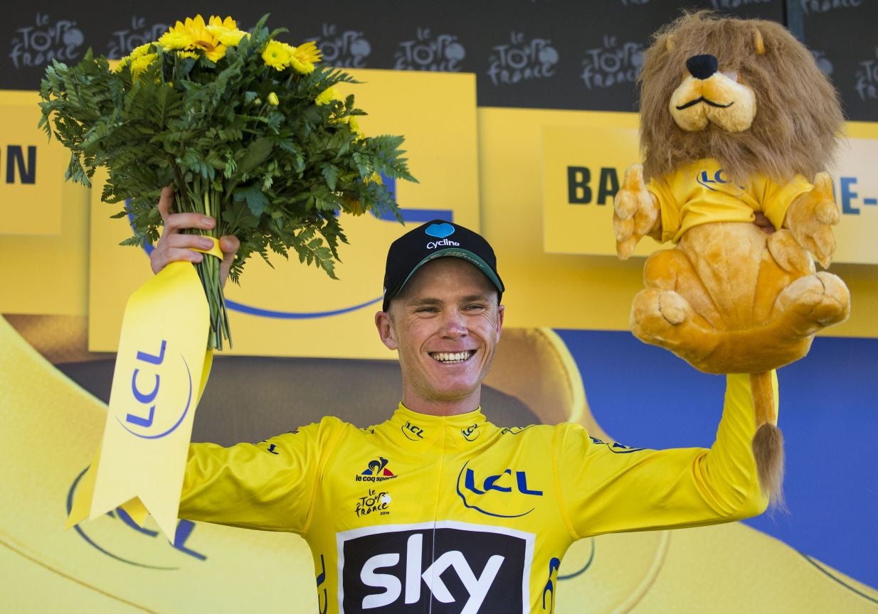 Chris Froome celebrates his stage eight victory to claim the leader's yellow jersey