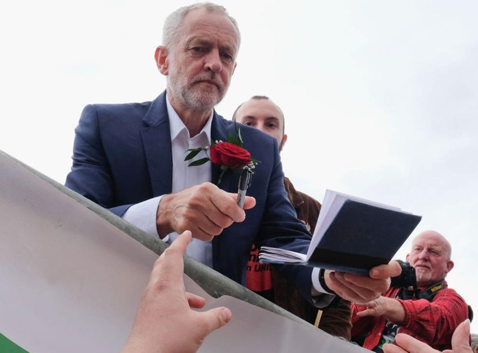 Jeremy Corbyn signs autographs for supporters following his speech during the 132nd Durham Miners Gala