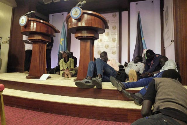 Journalists take cover inside the presidential residence, where leaders were meeting for talks but were interrupted by the outbreak of gunfire and artillery nearby