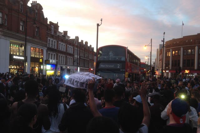 Black Lives Matter protesters assemble in the middle of a normally busy street in Brixton, south London, bringing the crossroads to an hours-long standstill