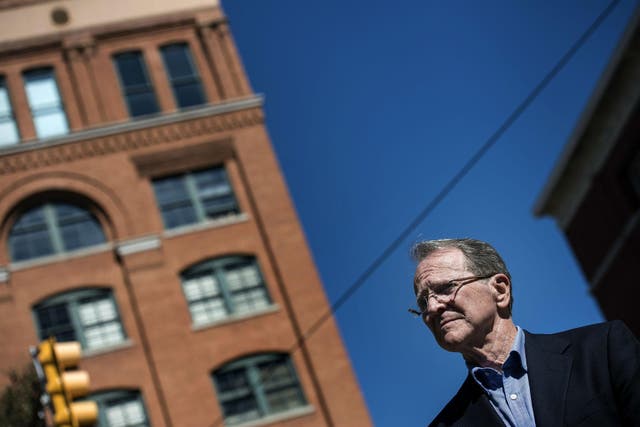Pierce Allman stands in Dealey Plaza in downtown Dallas, beneath the sixth-floor window of the Texas school book depository, from which Lee Harvey Oswald fired the shots that killed President John F Kennedy