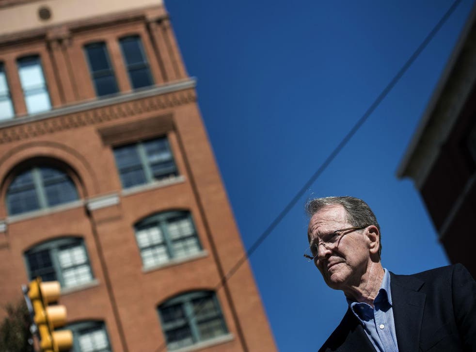 Pierce Allman stands in Dealey Plaza in downtown Dallas, beneath the sixth-floor window of the Texas school book depository, from which Lee Harvey Oswald fired the shots that killed President John F Kennedy