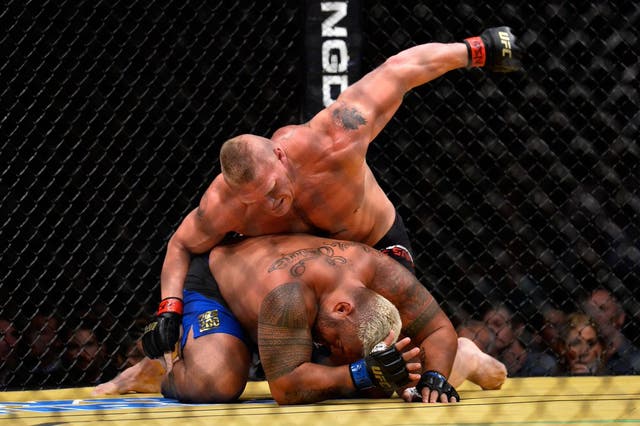 Brock Lesnar delivers a right hand to Mark Hunt
