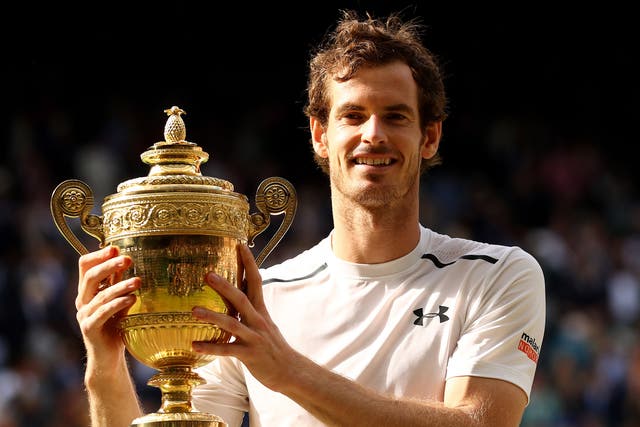 Andy Murray poses with the Wimbledon trophy after defeating Milos Raonic
