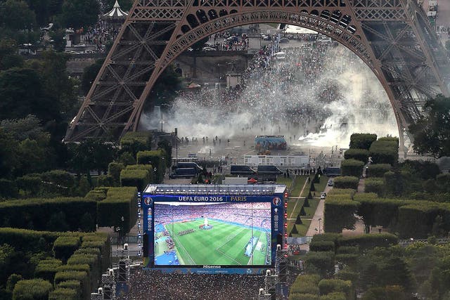 Violence breaks out between French police and supporters trying to enter the Paris fan park