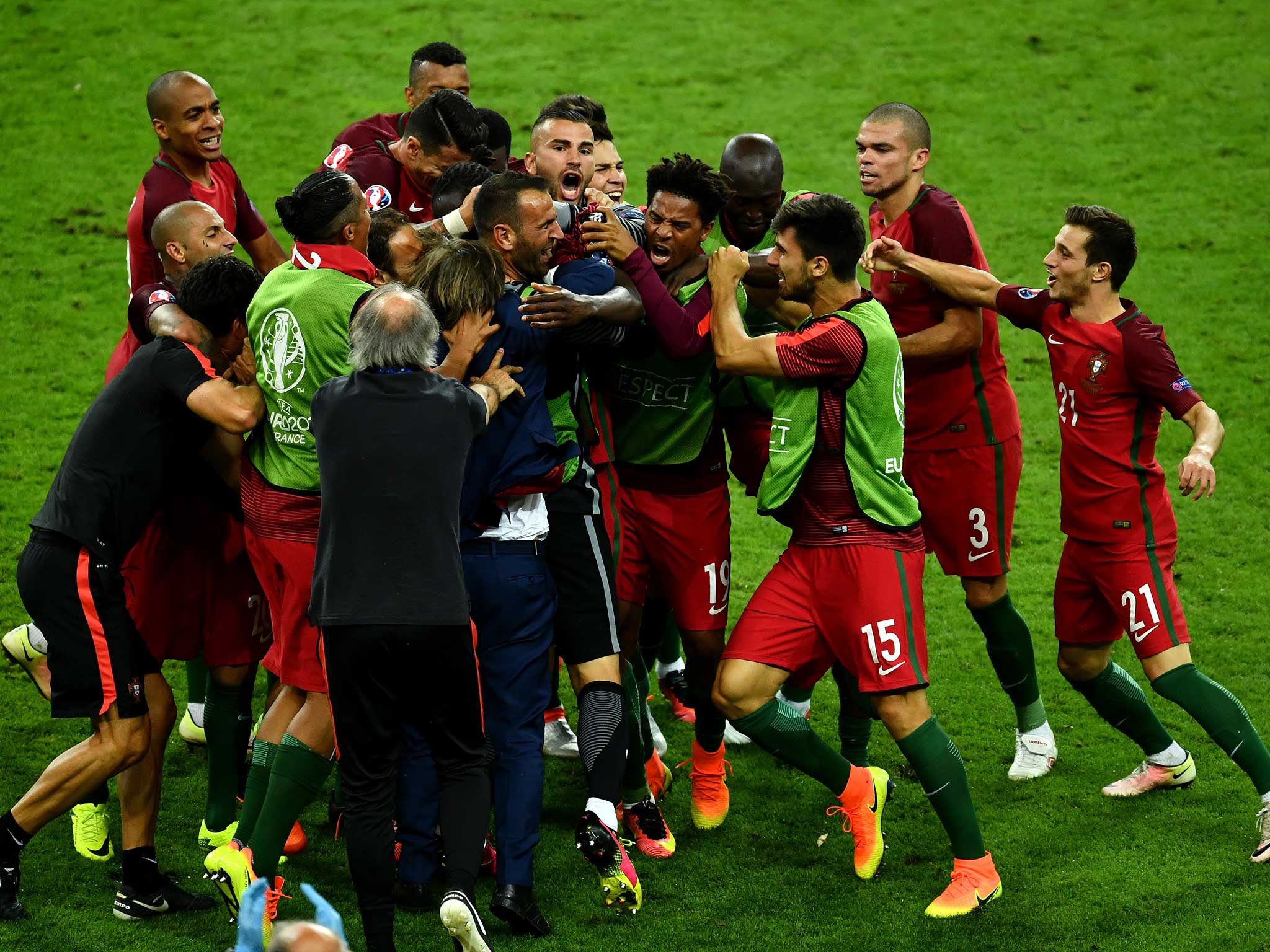 Eder is mobbed by his Portugal team-mates after scoring the winning goal