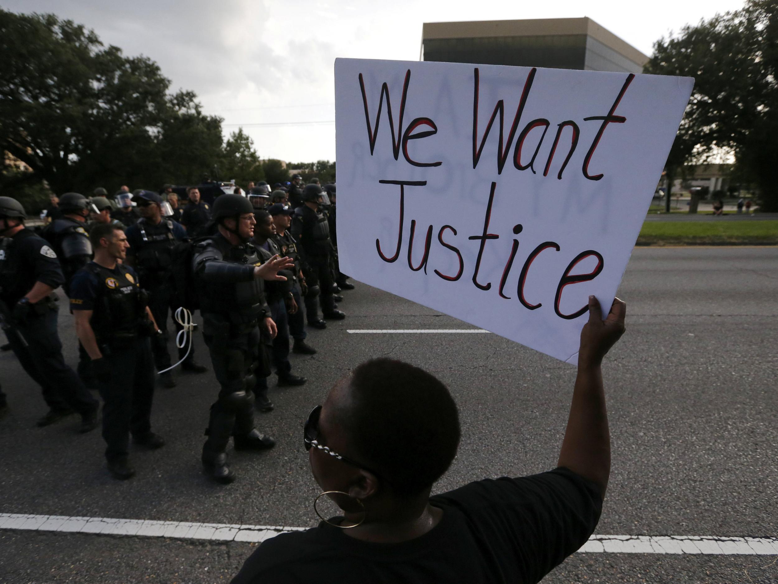 Demonstrators protest the shooting death of Alton Sterling near the headquarters of the Baton Rouge Police Department (Jonathon Bachman/ Reuters )