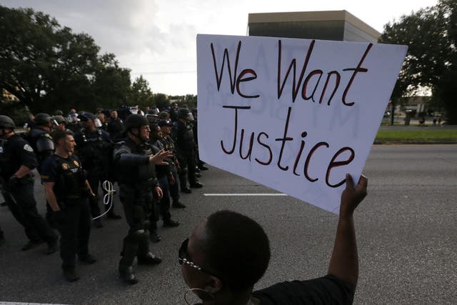 Demonstrators protest the shooting death of Alton Sterling near the headquarters of the Baton Rouge Police Department