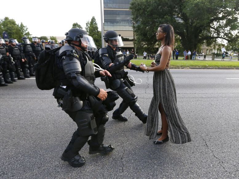 A demonstrator protesting the shooting death of Alton Sterling is detained by law enforcement near the headquarters of the Baton Rouge Police Department in Baton Rouge, Louisiana