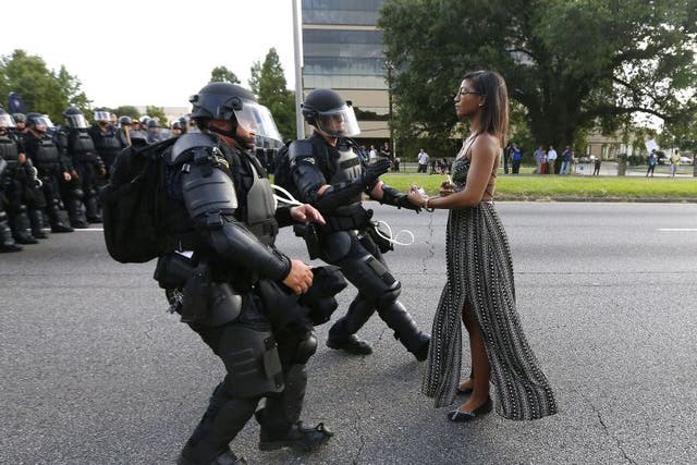 A demonstrator protesting the shooting death of Alton Sterling is detained by law enforcement near the headquarters of the Baton Rouge Police Department in Baton Rouge, Louisiana