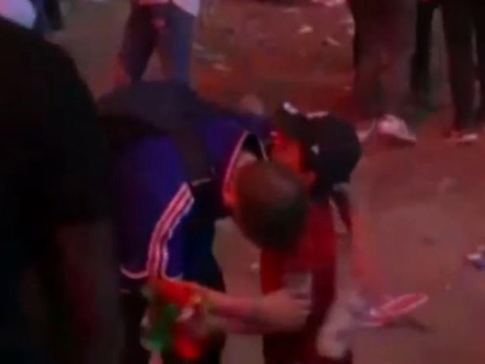 A France fan is consoled by a young Portuguese boy following the Euro 2016 final