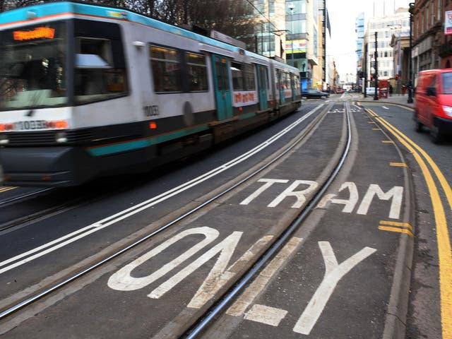 A tram travelling through Manchester's city centre