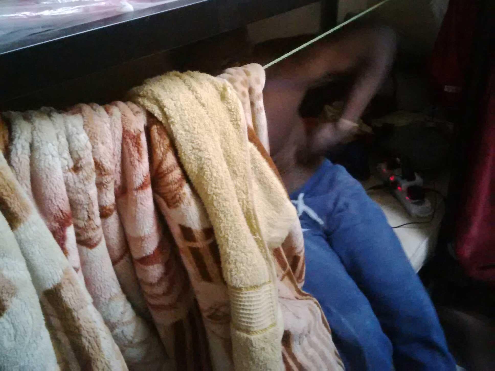 A migrant worker on a bunkbed in an eight-man dorm in Mussafah, Abu Dhabi