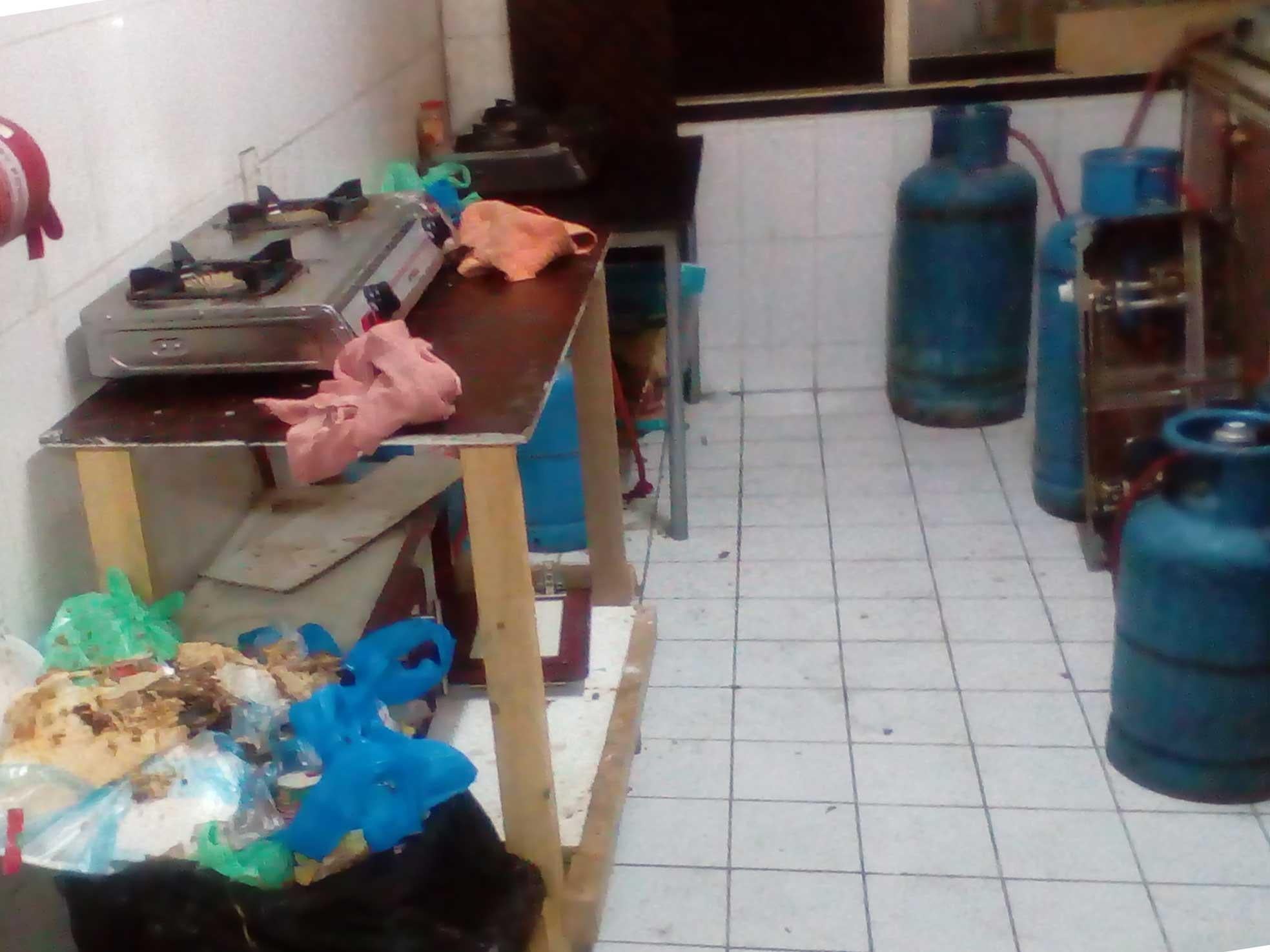 Twenty-four migrant workers share one kitchen in squalid conditions to prepare food after they return from an 11-hour day on a construction site