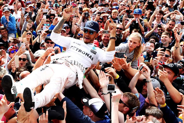 Lewis Hamilton crowd surfs after winning the British Grand Prix