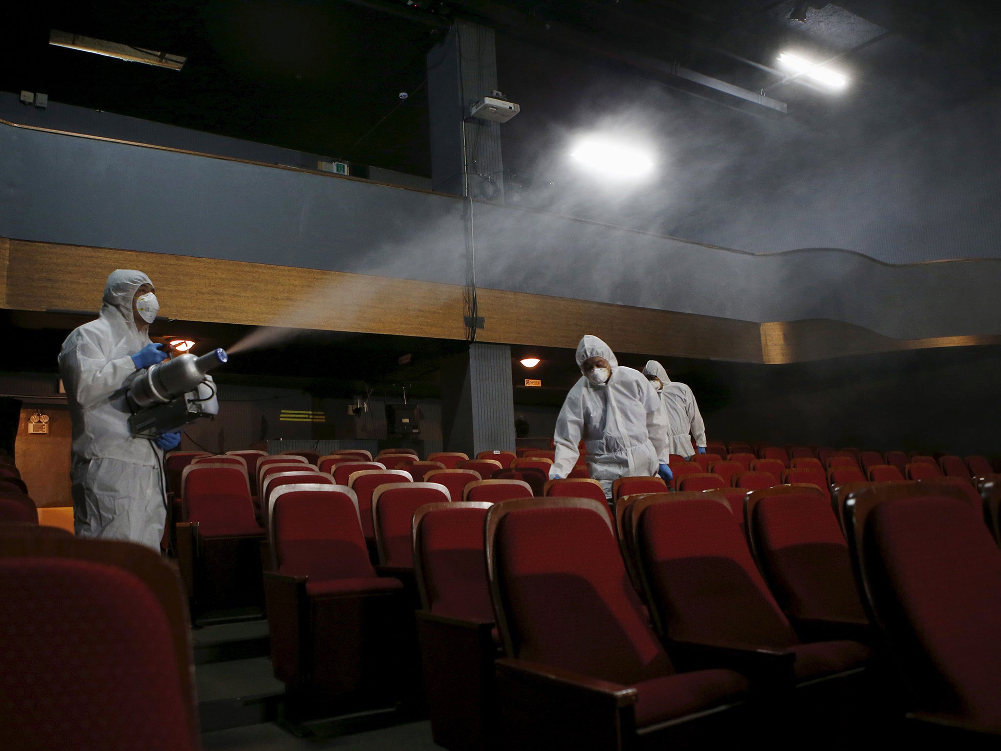 Employees from a disinfection company sanitize the interior of a theater in Seoul during the 2015 Mers outbreak