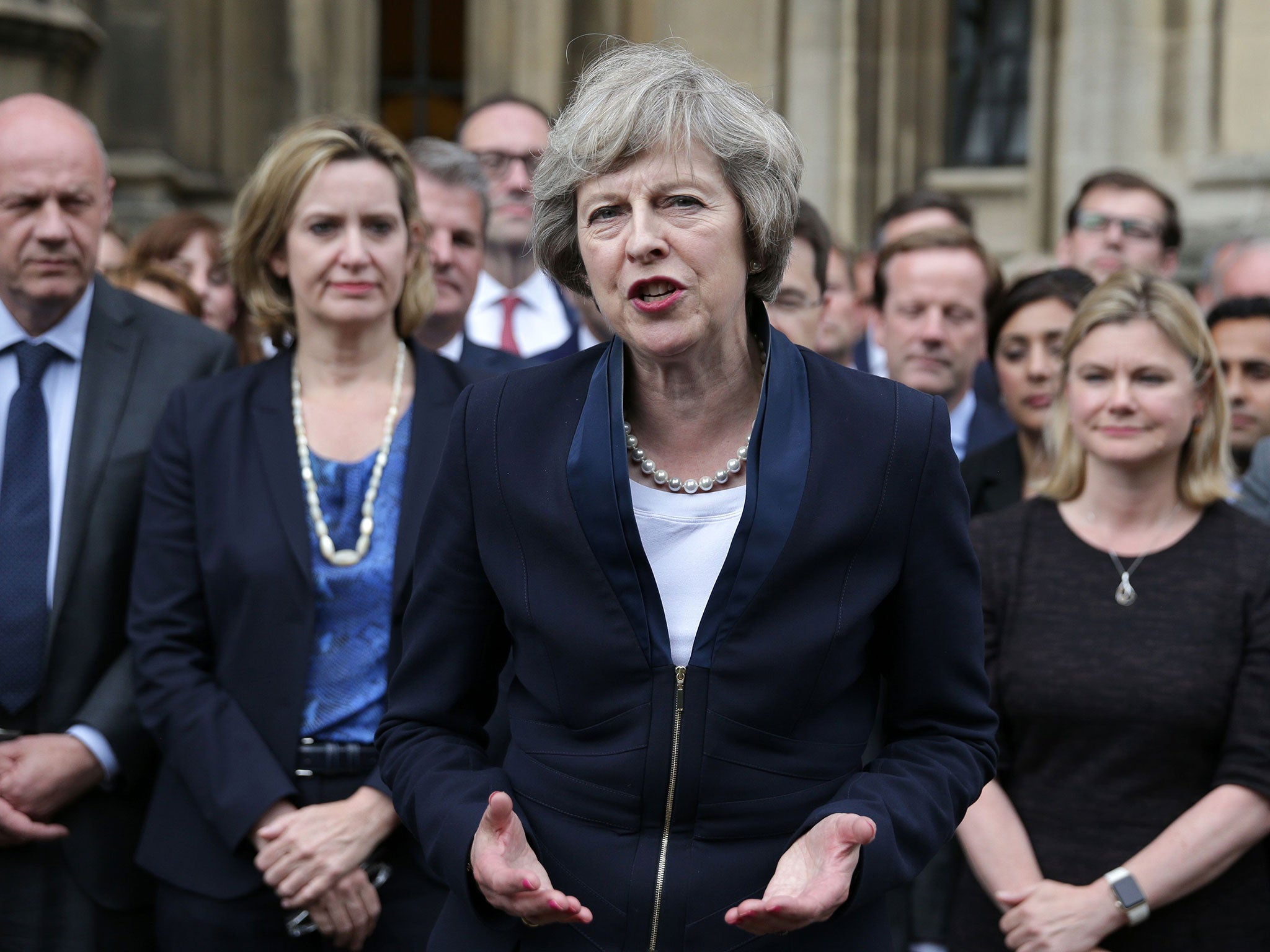 Britain's new Conservative Party leader Theresa May (C) speaks to members of the media at The St Stephen's entrance to the Palace of Westminster in London on July 11, 2016