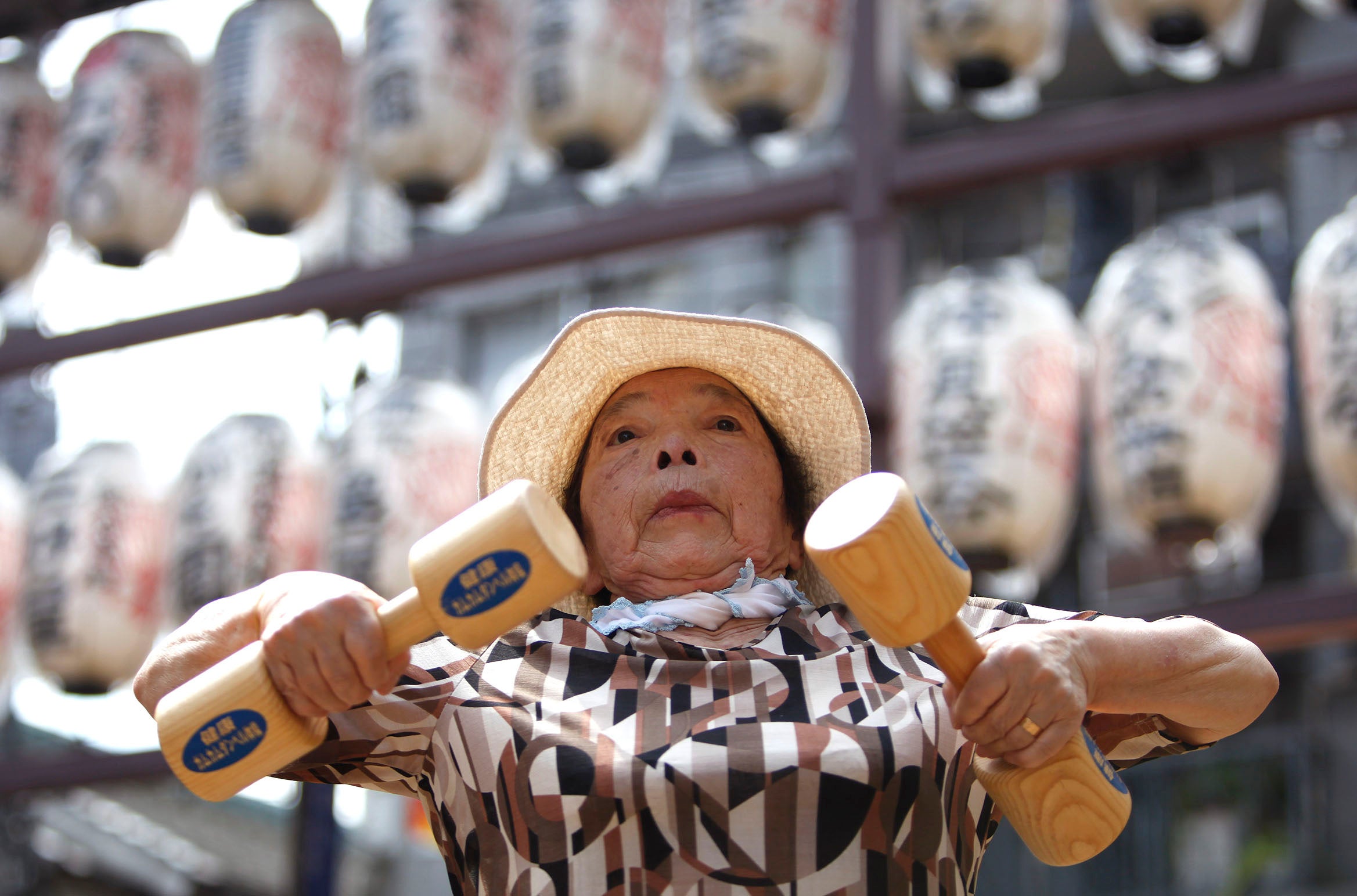 Hideko Kurihara, 79-year-old, exercises with wooden dumbbells during a health promotion event to mark Japan's "Respect for the Aged Day"