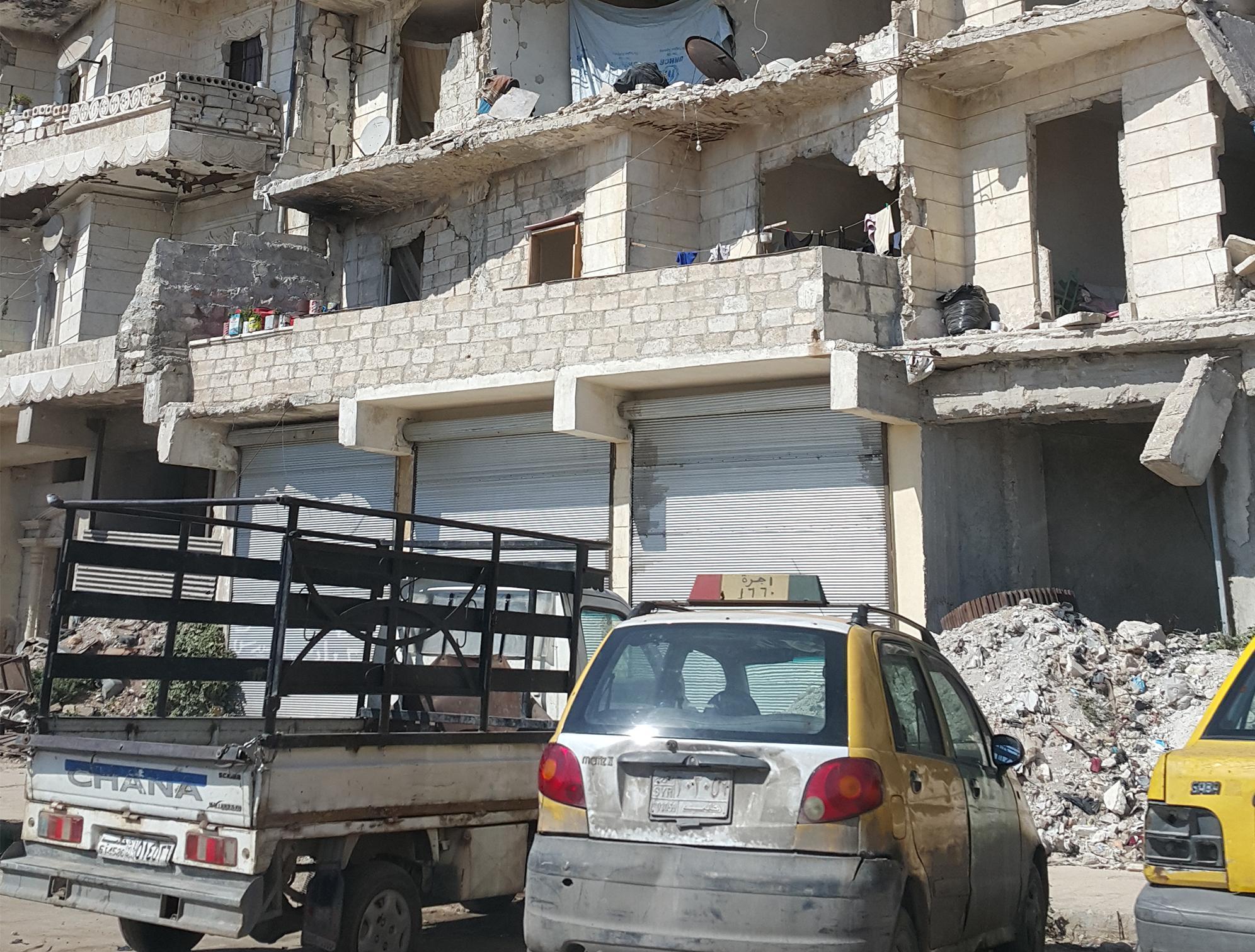 In Aleppo, parking beside the rubble of the city is as normal as the daily rumble of shells