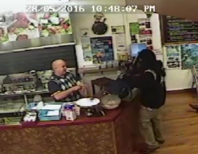 Takeaway owner ignores armed robber to calmly serve another customer