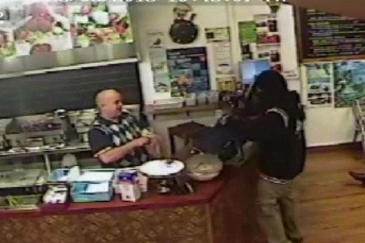 Takeaway owner ignores armed robber to calmly serve another customer ...