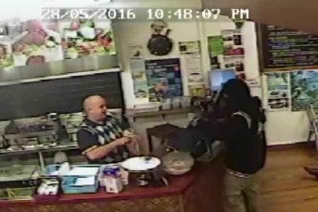 Takeaway owner ignores armed robber to calmly serve another customer