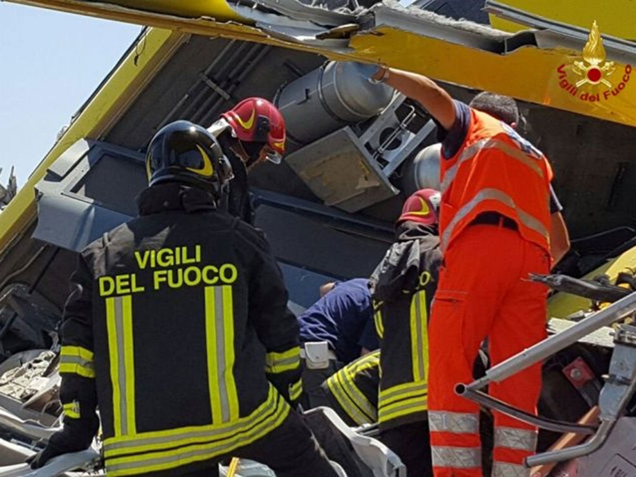 Firefighters work at the site where two passenger trains collided in the middle of an olive grove in the southern village of Corato, near Bari, Italy, in this handout picture released by Italian Firefighters, 12 July, 2016