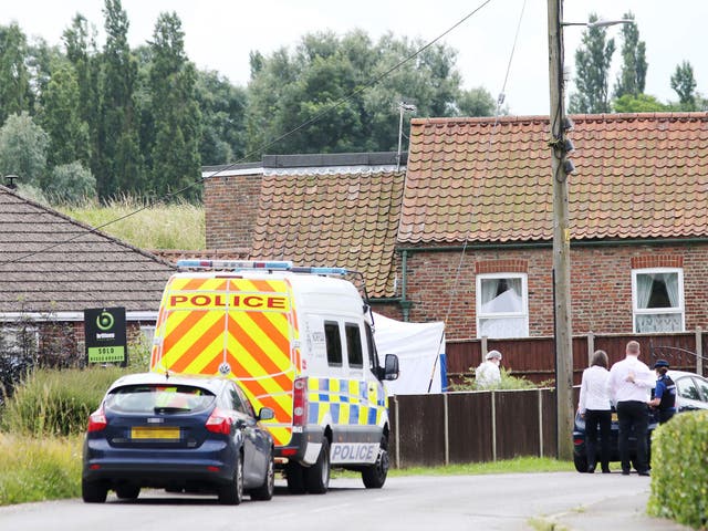 Police at the scene in Stow Road, Magdalen, where a man and a woman have died in a shooting