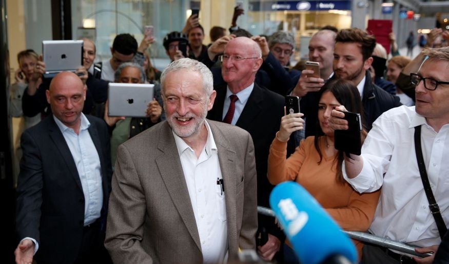 Supporters of Labour leader Jeremy Corbyn greet him after the announcement that he is allowed by the NEC to stand in the party's leadership election without needing to secure nominations