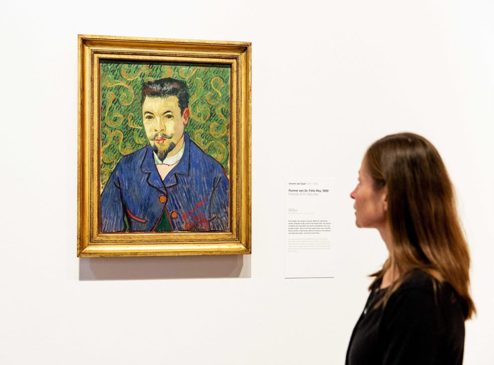 Conservator Nienke Bakker looks at the painting 'Dr. Felix Rey' by Dutch painter Vincent van Gogh displayed as part of the exhibition 'On the Verge of Insanity. Van Gogh and his illness'