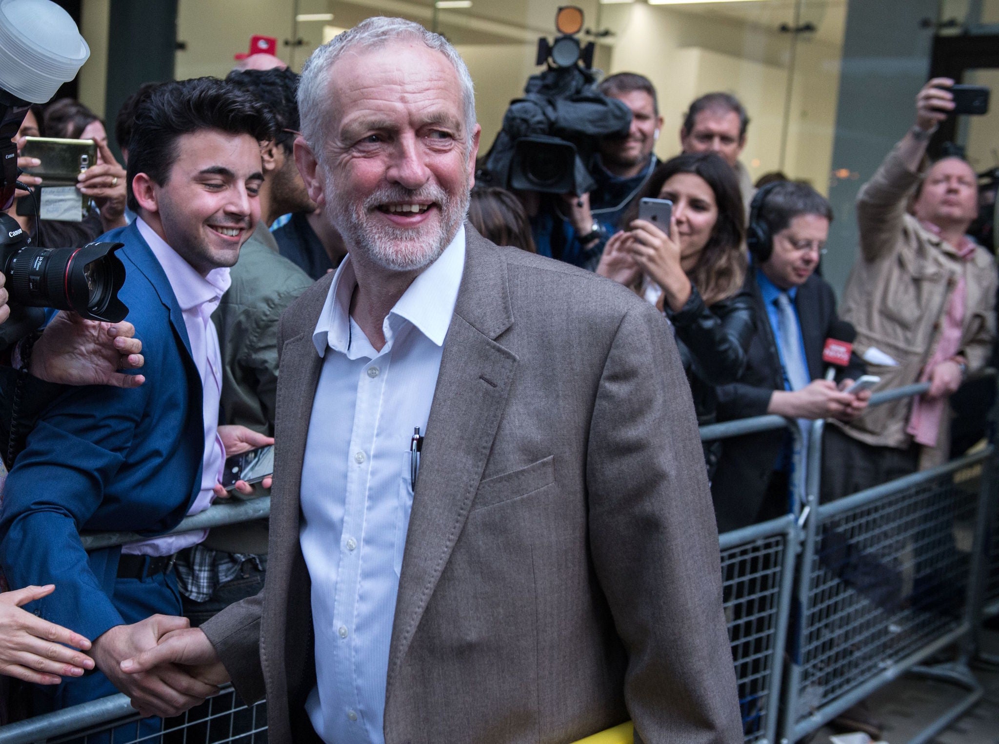 Jeremy Corbyn smiles as he meets supporters and members of the media after attending a meeting of Labour's National Executive Committee in London on July 12, 2016